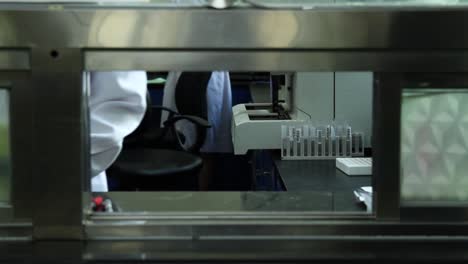 doctor putting gloves on by a window