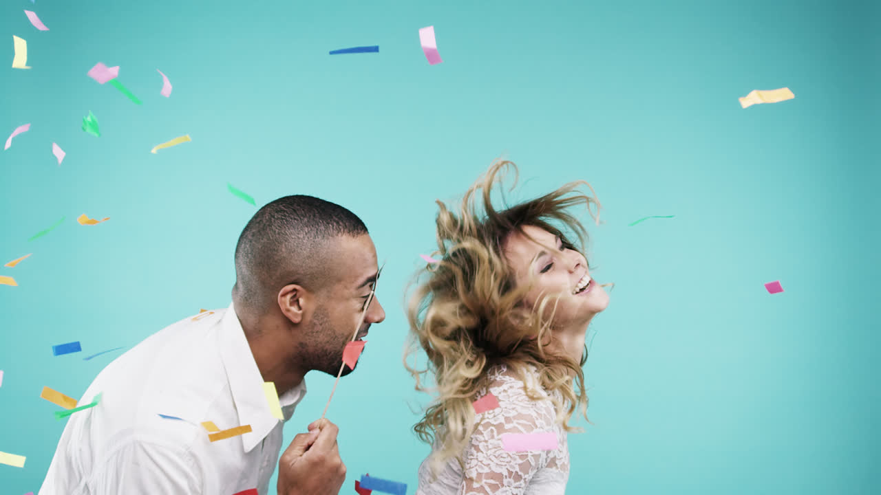 Attractive mixed race couple dancing slow motion party photo booth