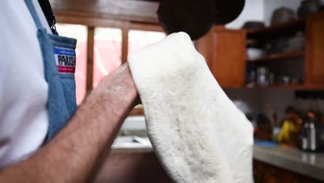 slowmo shot of a chef stretching a home made pizza