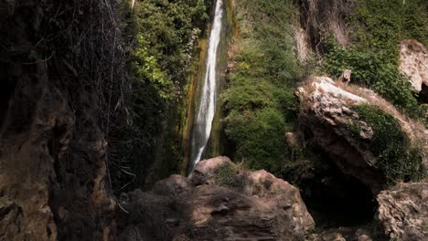 tall and steep waterfall with narrow stream in spain