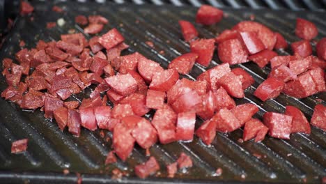 grilled cubed sausage on a grill