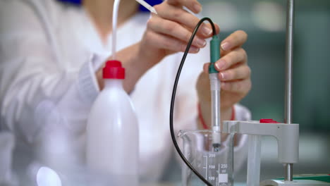 scientist woman working in lab. lab worker cleaning laboratory equipment