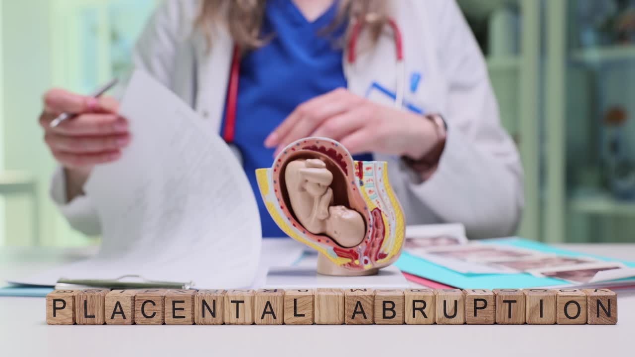 Wooden cubes on desk form phrase placental abruption by doctor
