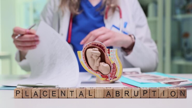 Wooden cubes on desk form phrase placental abruption by doctor