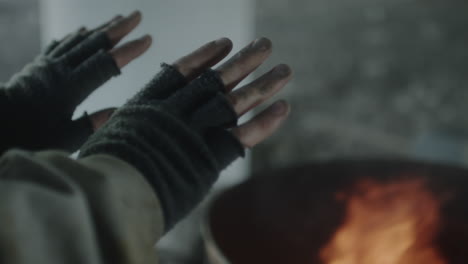 hands warming by a fire