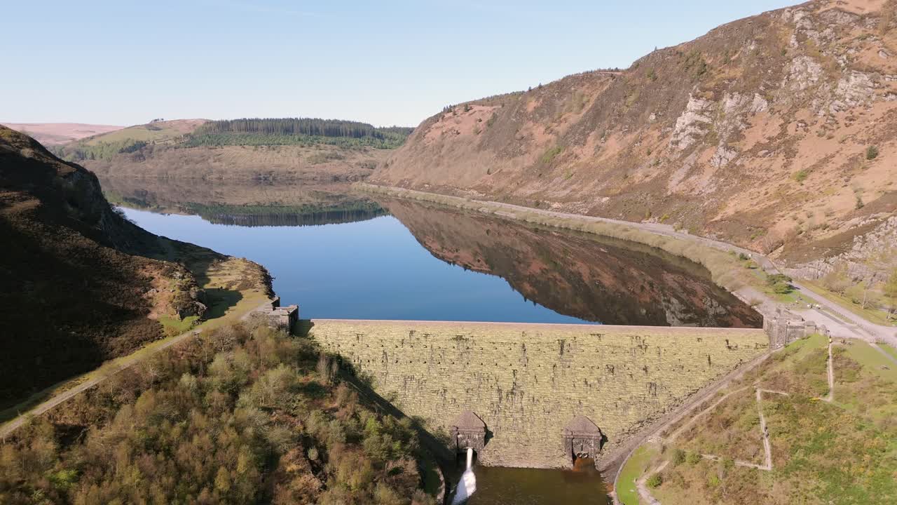 An aerial view of Caban Coch dam and reservoir on a sunny spring day in the Elan valley, Powys, Wales