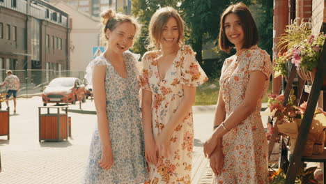 three friends in floral dresses