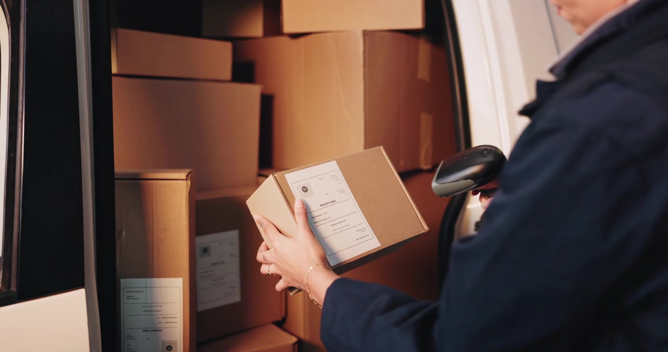 Delivery Driver Scanning Package Label Before Loading into Van