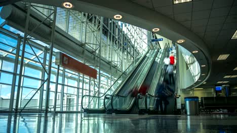 time lapse of airport escalators with people going up and down