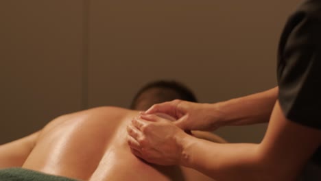 professional massage therapist performing relaxation massage