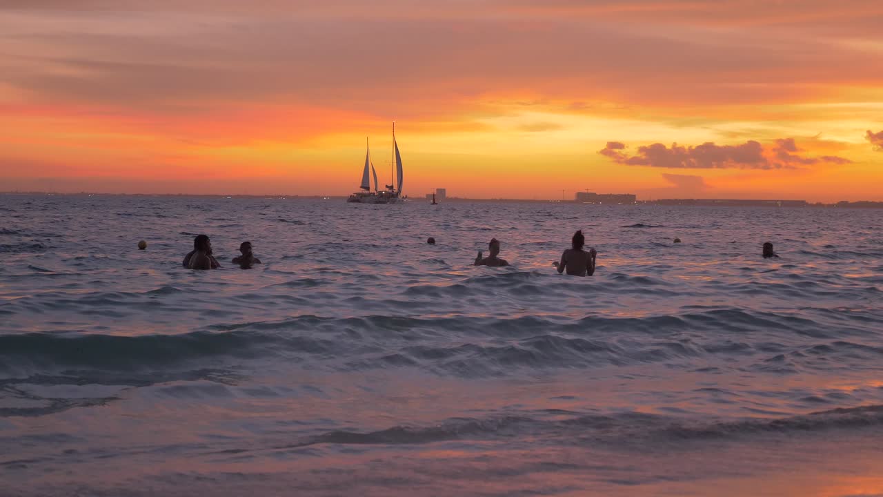 A slow motion handheld shot of a crowded beach during the golden hour
