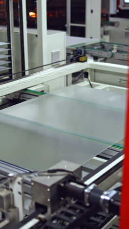 robotic machine makes solar panel indoors. automated technology of producing solar cells in a modern factory. vertical video