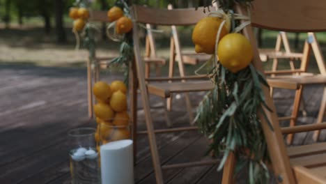 outdoor wedding ceremony decor with lemons and olive branches