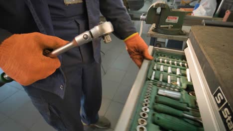 car mechanic looking for something inside his tools drawer close up video.