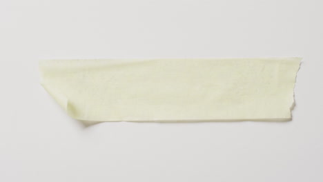 video of close up of yellow scrap of paper with copy space on white background