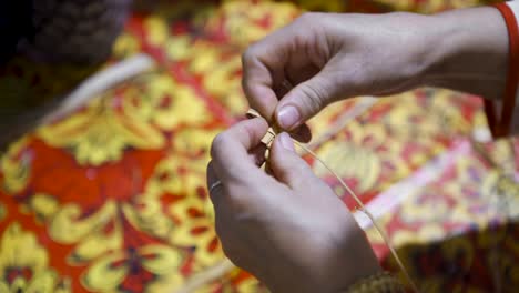 woman weaving with straw