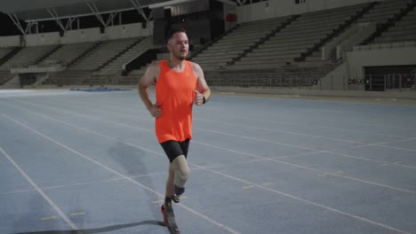 caucasian disabled male athlete with prosthetic leg training, running