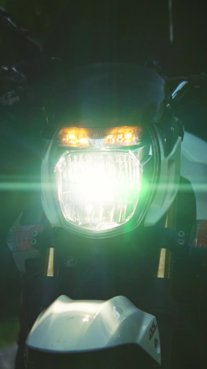 Motorcycle Headlight Turning On in the Dark