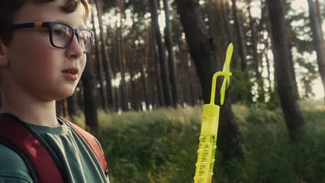 kid playing with toy in the forest