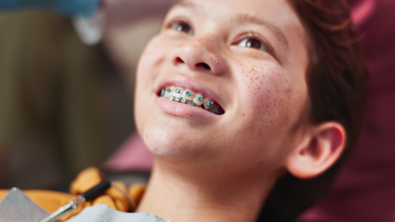 Teenager at the dentist getting her braces checked