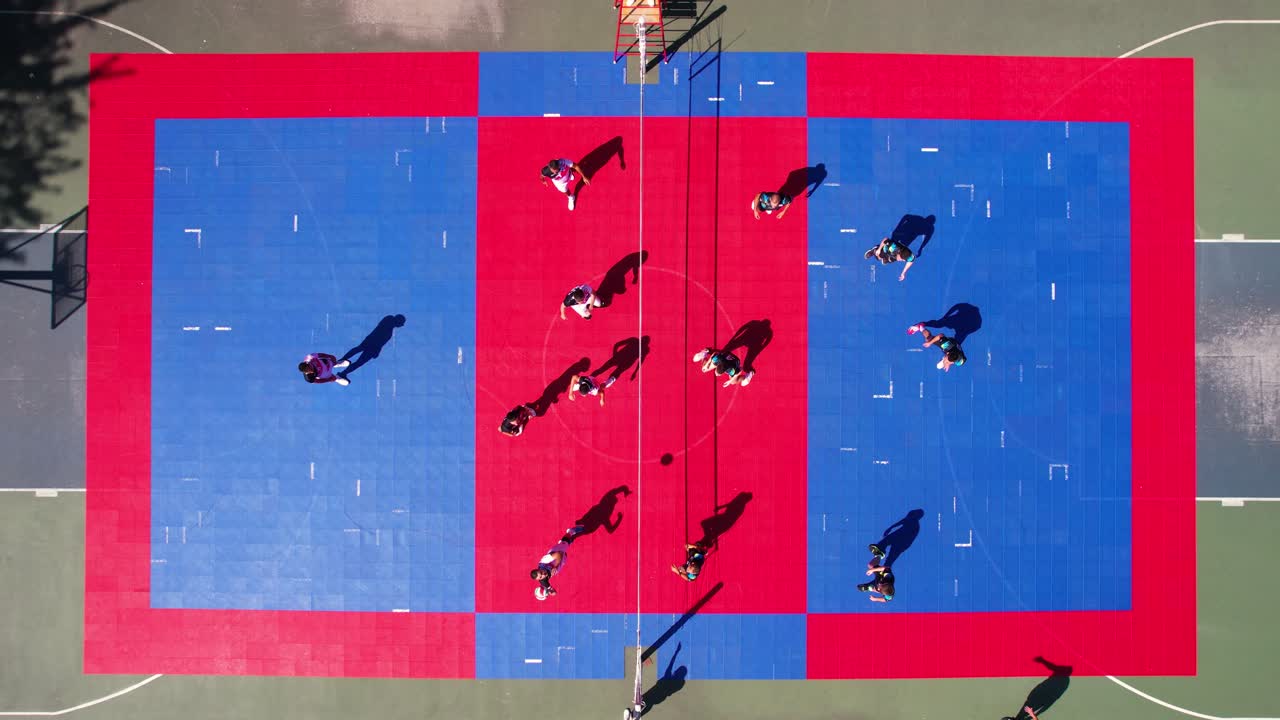 Playing Volleyball on Outdoor Open Court on Sunny Summer Day, Top Down Drone Shot