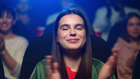 cheerful woman enjoying interesting film in movie theater