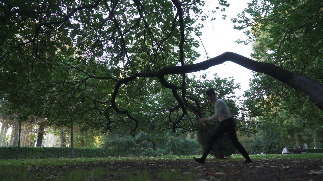 Young man training parkour jumps at park