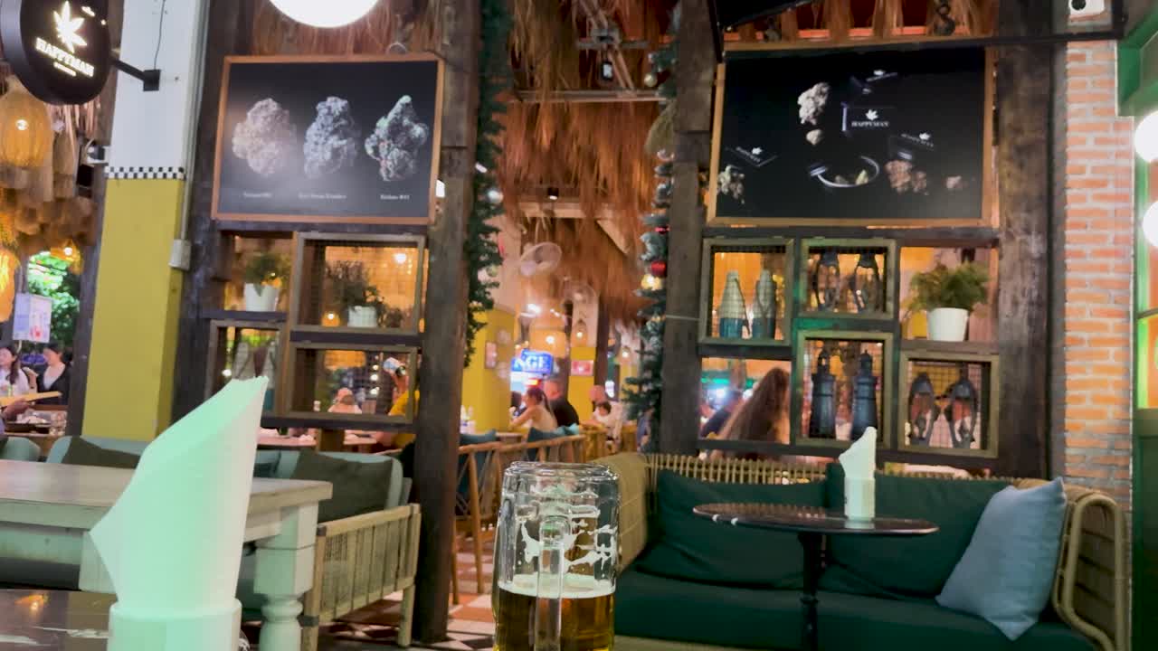 Colorful outdoor bar with lively decor and ambient lighting, capturing a vibrant nightlife scene at Kata Beach, Phuket