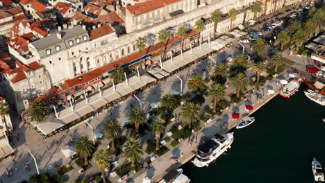 locals and tourists at riva, bustling promenade with eateries on a sunny day in split, croatia