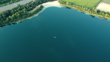 aerial view of a serene lake with kayaks