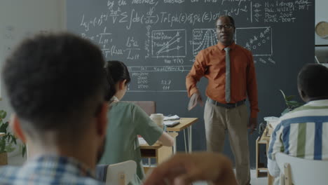 university professor teaching a diverse group of students in a classroom