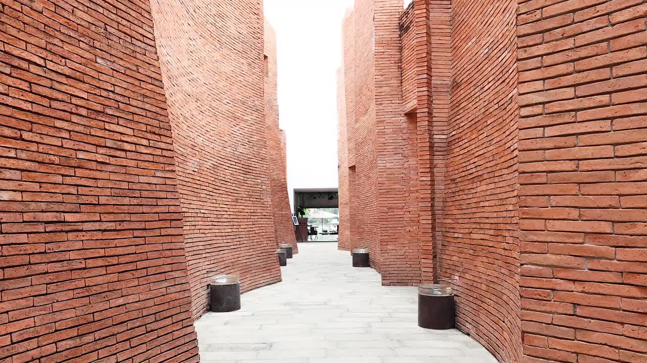 카메라 는 벽돌 의 기둥 구조 를 둘러싸고 서 있다