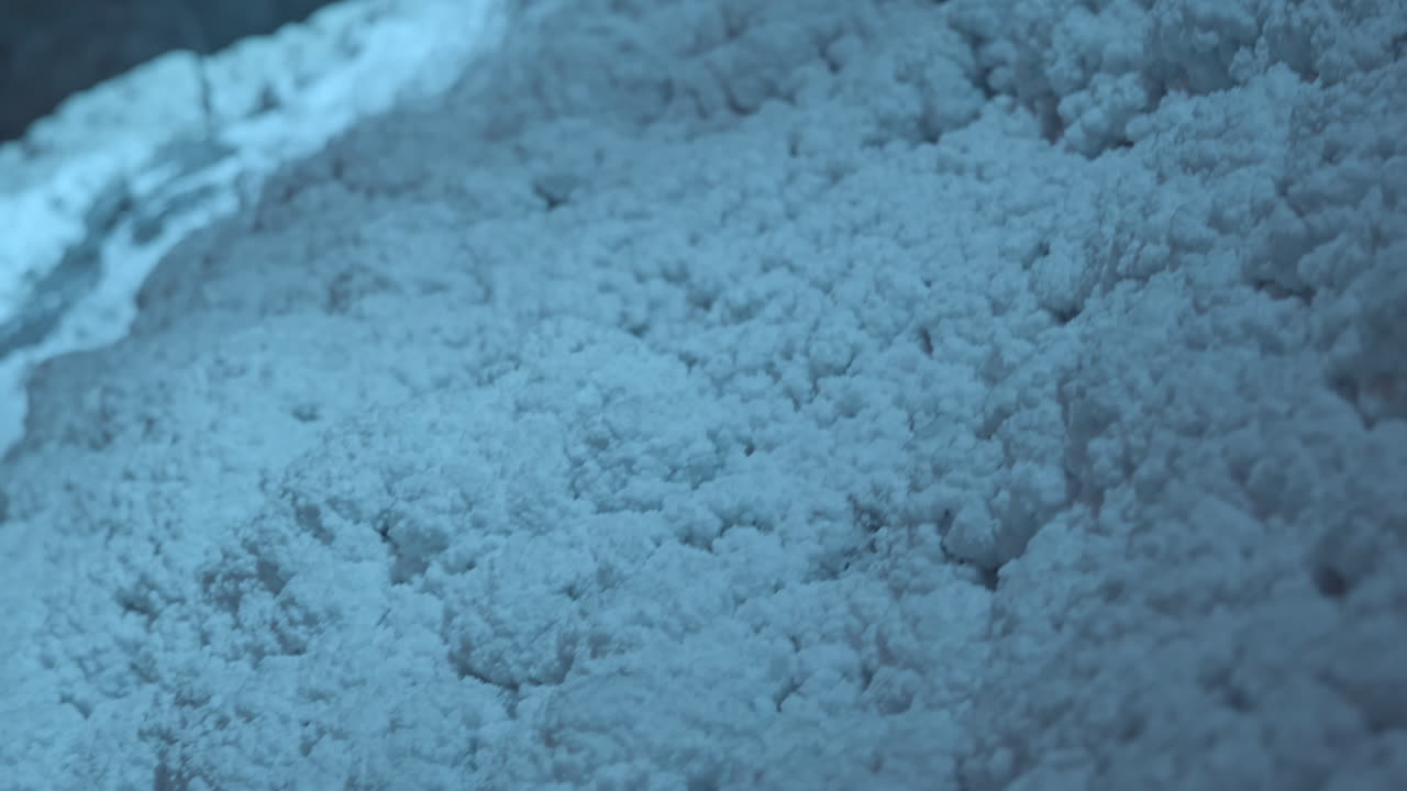slowmotion shot of salt deposits bunched together on the wall of a salt mine
