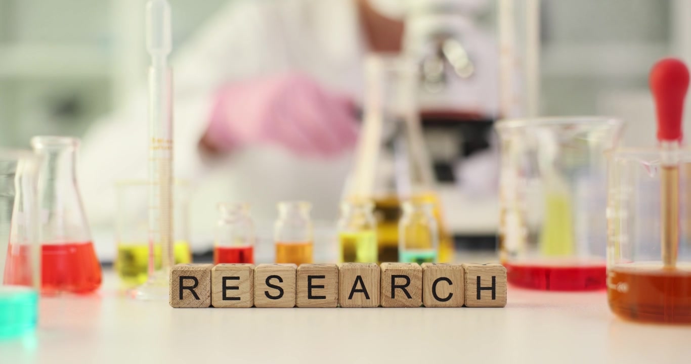 Word research from cubes against worker with microscope