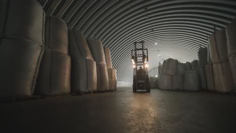 warehousing. forklift driver stacking big bag of raw material in warehouse. many bags of raw materials in the warehouse