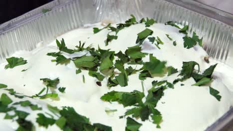 creamy sauced meat dish in aluminum container