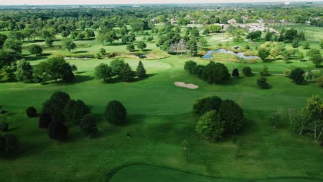 aerial drone rotating shot over golf club covered