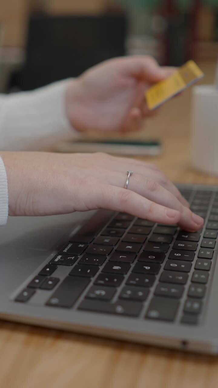 Person using a laptop for online shopping with a credit card