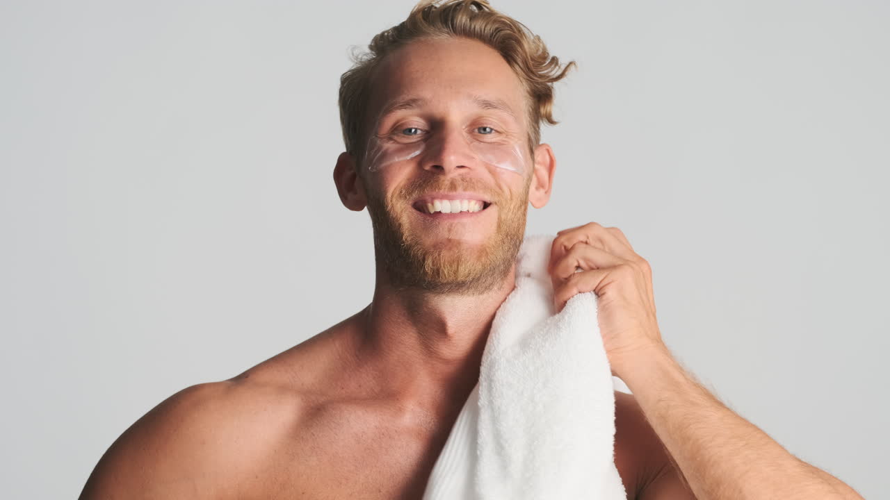 Handsome strong guy with eye patches and towel