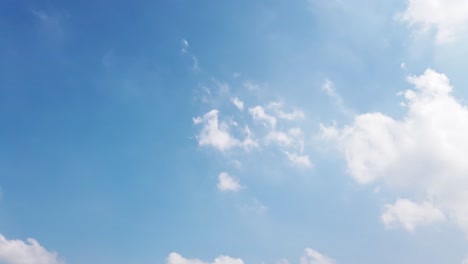 white puffy clouds and blue sky time-lapse with long second duration for background and graphics in daylight