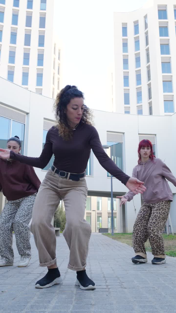 Energetic dancers performing modern choreography outdoors