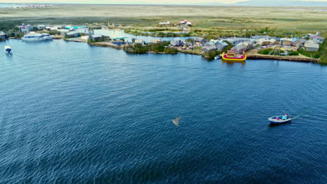 Static-aerial-overview-of-boat-and-Uros-Island-floating-homes-on-Lake-Titicaca