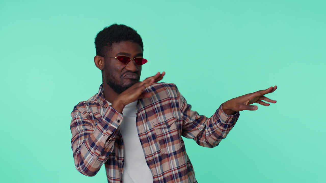 African american man listening music dancing disco fooling around having fun, gesticulating hands