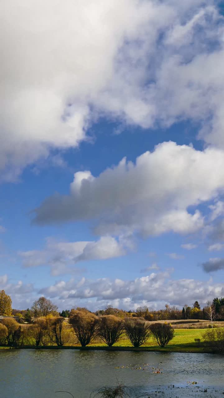 Vertical countryside timelapse with clouds rolling in. Autumn season in rural landscape.