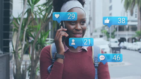 animation of social media icons and data over african american woman using smartphone