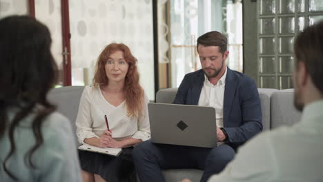 business meeting between two women and two men at an office 4