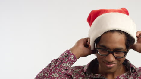 CU-Smiling-Young-Man-Puts-on-Santa-Hat