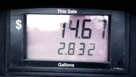 gas station pump prices high over 5 five dollars per gallon 5.15 regular starting at 0 pumping to 69 sped up to be under 60 seconds with dramatic suspenseful camera movements. in cinema 4k 60fps