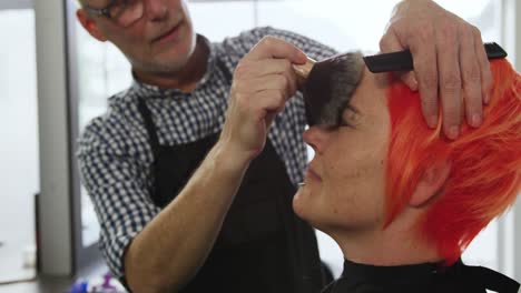 front view hairdresser cleaning the face of a woman