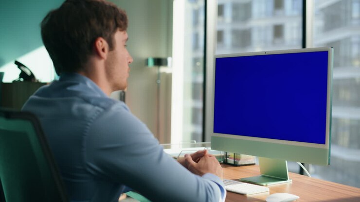 Dipendente sconosciuto che parla a un monitor con schermo blu in primo piano. CEO che gesticola in videochiamata